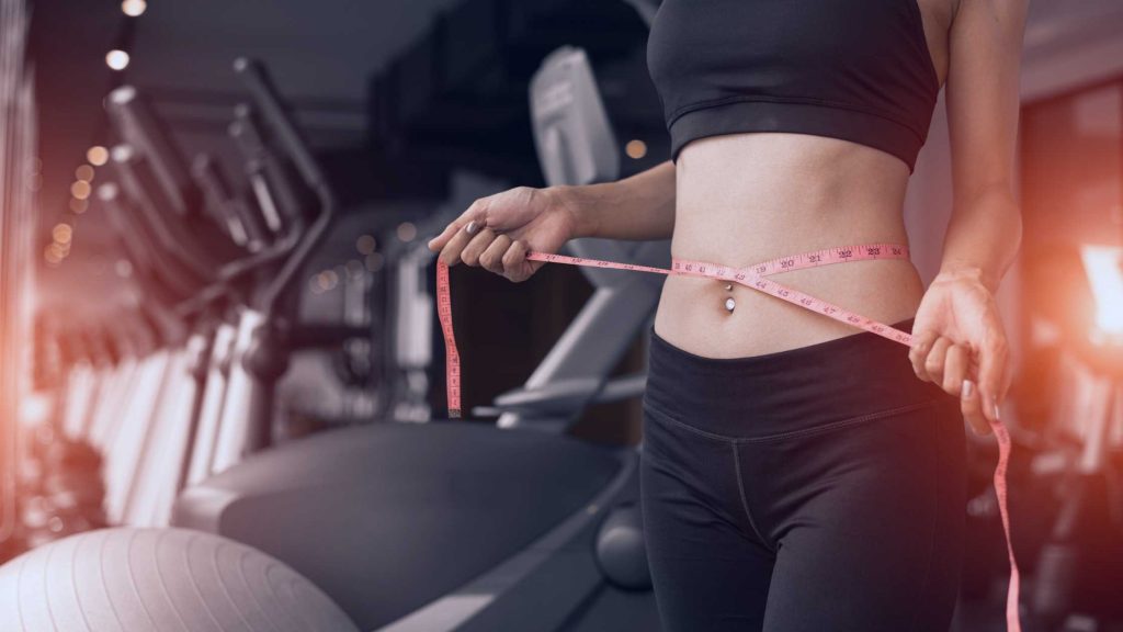 woman in gym with natural weight loss NYC program